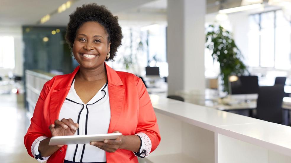 Confident smiling woman in office space